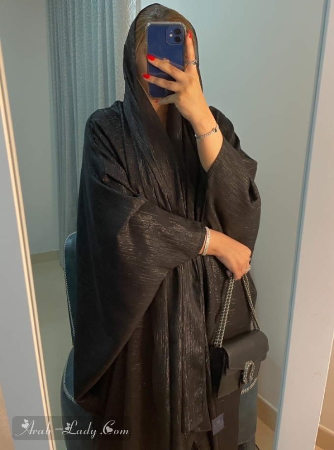 Black shimmery bisht abaya with matching headscarf.