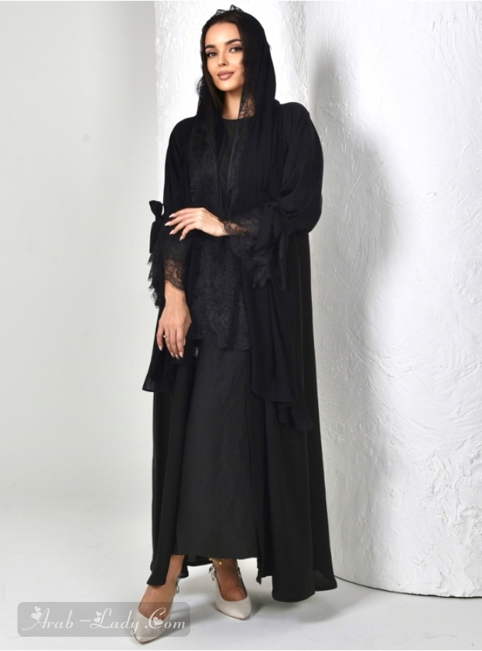 Black abaya with flounced sleeves and lace trimmings. Comes with a matching headscarf.