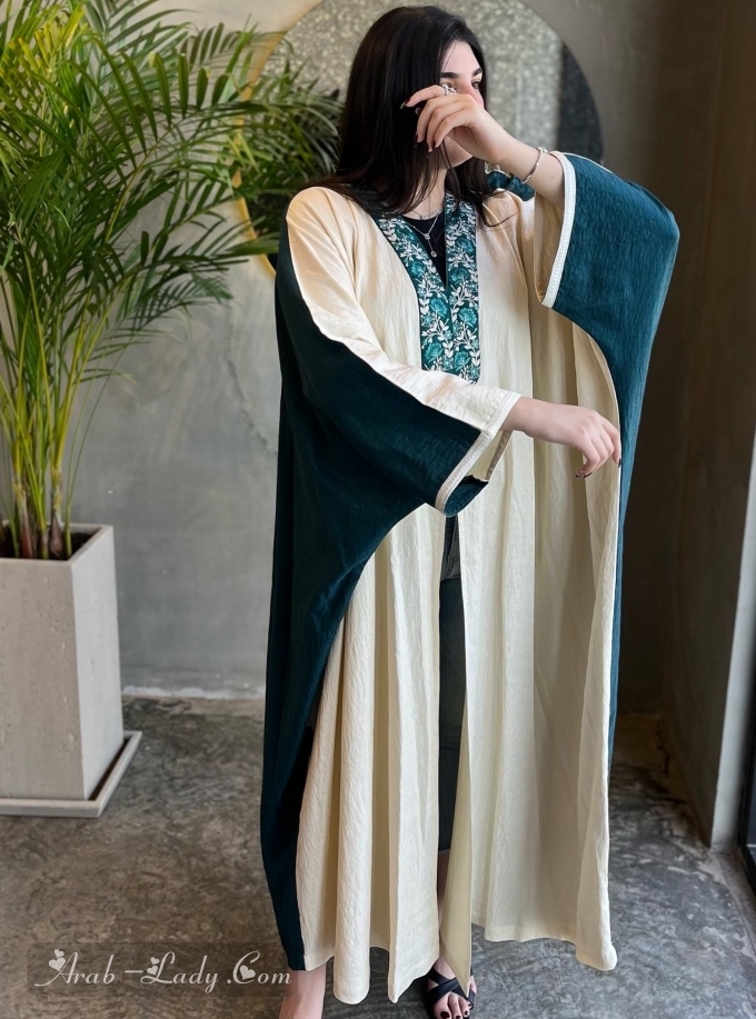 Abaya in teal and cream colors with embroidered front trimmings. Comes with a plain headscarf.