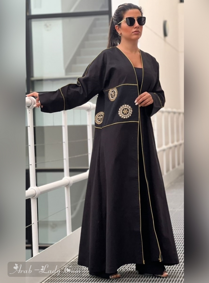 Black abaya with pearl and mirror embellishments.